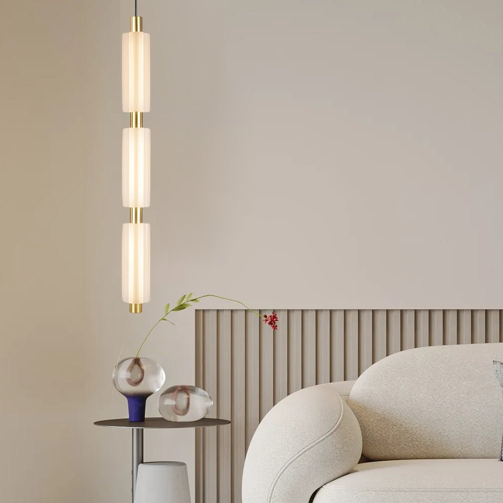 1. **WINSLOW ACRYLIC TRIO PENDANT LAMP**: A striking modern luminaire featuring three cylindrical shades in a sophisticated gold finish, perfect for illuminating dining areas or living spaces with a contemporary flair.

2. **CAMPBELL SINGLE CYLINDER HANGI