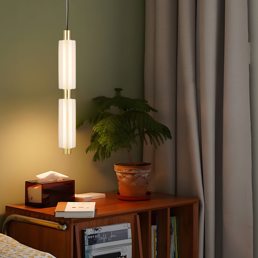1. **WINSLOW ACRYLIC TRIO PENDANT LAMP**: A striking modern luminaire featuring three cylindrical shades in a sophisticated gold finish, perfect for illuminating dining areas or living spaces with a contemporary flair.

2. **CAMPBELL SINGLE CYLINDER HANGI