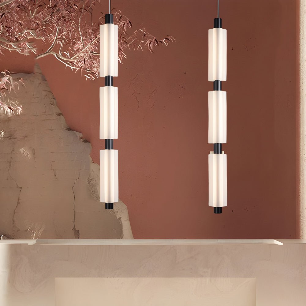 1. **WINSLOW ACRYLIC TRIO PENDANT LAMP**: A striking modern luminaire featuring three cylindrical shades in a sophisticated gold finish, perfect for illuminating dining areas or living spaces with a contemporary flair.

2. **CAMPBELL SINGLE CYLINDER HANGI