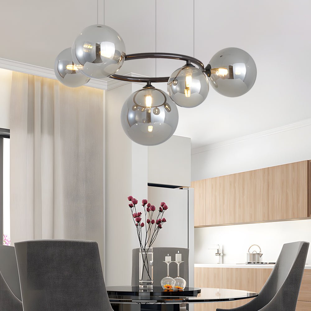 WILLOUGHBY SPHERE 5-BULB DIMMABLE CHANDELIER"  
2. "FENWICK TRIO-LEVEL GLASS ORB LIGHTING FIXTURE"  
3. "CHARLESTON 9-BULB CONTEMPORARY GLASS PENDANT"  
4. "HASTINGS CIRCULAR 7-LIGHT GLASS CHANDELIER"  
5. "BRIDGEMAN ROUNDEL DIMMABLE CHANDELIER WITH GLASS