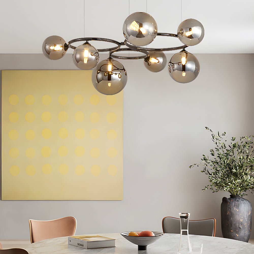 WILLOUGHBY SPHERE 5-BULB DIMMABLE CHANDELIER"  
2. "FENWICK TRIO-LEVEL GLASS ORB LIGHTING FIXTURE"  
3. "CHARLESTON 9-BULB CONTEMPORARY GLASS PENDANT"  
4. "HASTINGS CIRCULAR 7-LIGHT GLASS CHANDELIER"  
5. "BRIDGEMAN ROUNDEL DIMMABLE CHANDELIER WITH GLASS