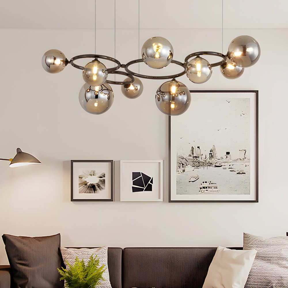 WILLOUGHBY SPHERE 5-BULB DIMMABLE CHANDELIER"  
2. "FENWICK TRIO-LEVEL GLASS ORB LIGHTING FIXTURE"  
3. "CHARLESTON 9-BULB CONTEMPORARY GLASS PENDANT"  
4. "HASTINGS CIRCULAR 7-LIGHT GLASS CHANDELIER"  
5. "BRIDGEMAN ROUNDEL DIMMABLE CHANDELIER WITH GLASS