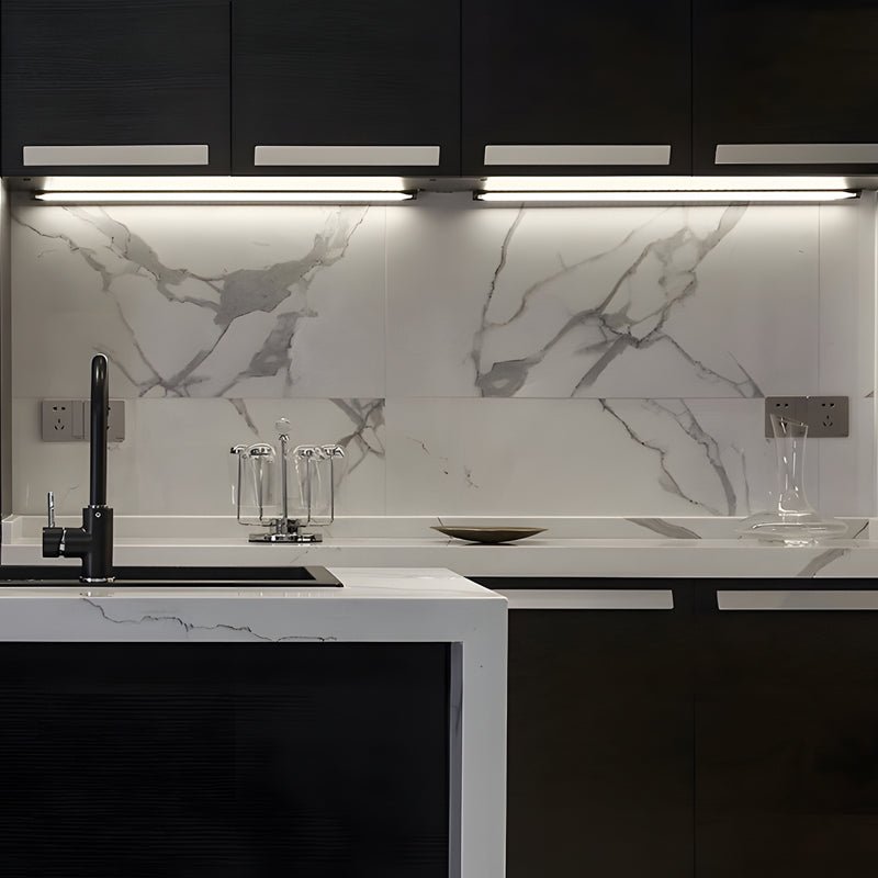 1. **WILLOUGHBY LED LUMINAIRE SET** - A collection of six elongated 12V LED bars designed for seamless surface mounting, ideal for illuminating cabinets with precision.

2. **SAVILLE SHIMMER STRIP LIGHTS** - Six sleek, surface-mounted LED strips that deli