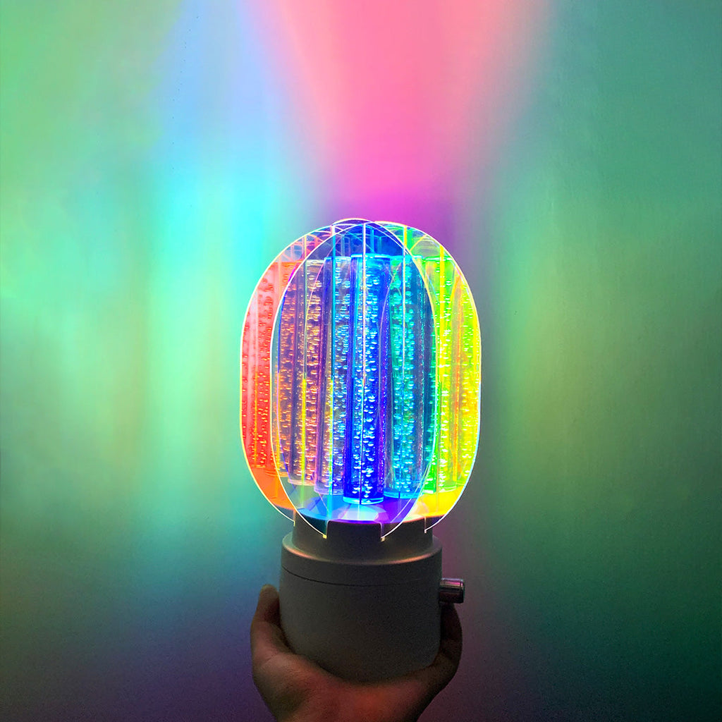 1. "VIVIENNE RAINBOW METAL TABLE LAMP"  
   A vibrant blend of colors and artistic design, this aluminum table lamp radiates warmth and creativity with its unique LED illumination.

2. "HAMPSTEAD ARTISANAL RAINBOW LAMP"  
   A striking fusion of color and