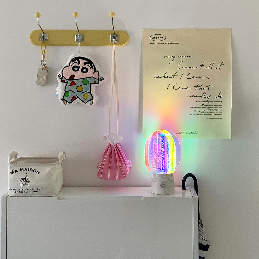 1. "VIVIENNE RAINBOW METAL TABLE LAMP"  
   A vibrant blend of colors and artistic design, this aluminum table lamp radiates warmth and creativity with its unique LED illumination.

2. "HAMPSTEAD ARTISANAL RAINBOW LAMP"  
   A striking fusion of color and