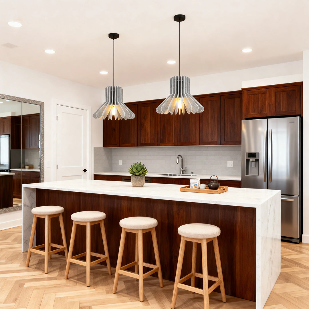 1. **MONTGOMERY FELT-ENCLOSED PENDANT LUMINAIRE**  
   A sophisticated pendant light featuring a sound-absorbing felt exterior and a robust iron frame, perfect for enhancing ambiance in any room.

2. **WINSLOW IRON & FELT HANGING ILLUMINATOR**  
   An inn