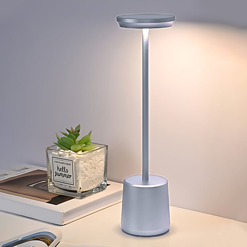 "WINTHORPE WIRELESS ILLUMINATION TABLE LAMP" 

This sophisticated lamp features a rechargeable LED design, providing versatile ambient lighting without the constraints of cords. Its modern aesthetic is perfect for any setting, seamlessly blending function