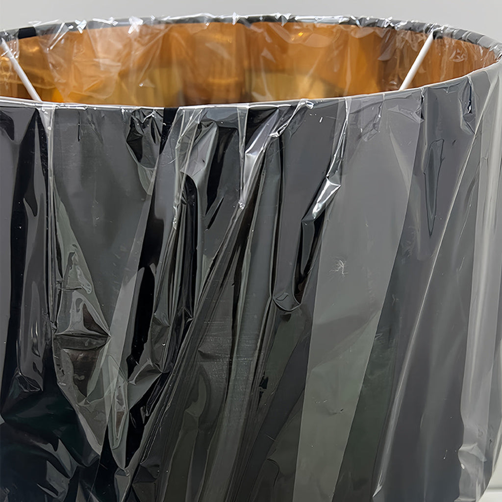 RAVENWOOD GOLDEN HORIZON TABLE LANTERN WITH SCULPTED BASE AND DRUM SHADE