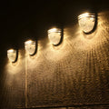 Hawthorne Solar-Infused Noir Lanterns, Set of Four"  
2. "Wellington Nightfall Solar Wall Illuminaries, Quad Set"  
3. "Chesterfield Solar-Ember Wall Fixtures, Pack of Four"  
4. "Carmichael Solar-Illuminated Ebony Fence Sconces, Four-Pack