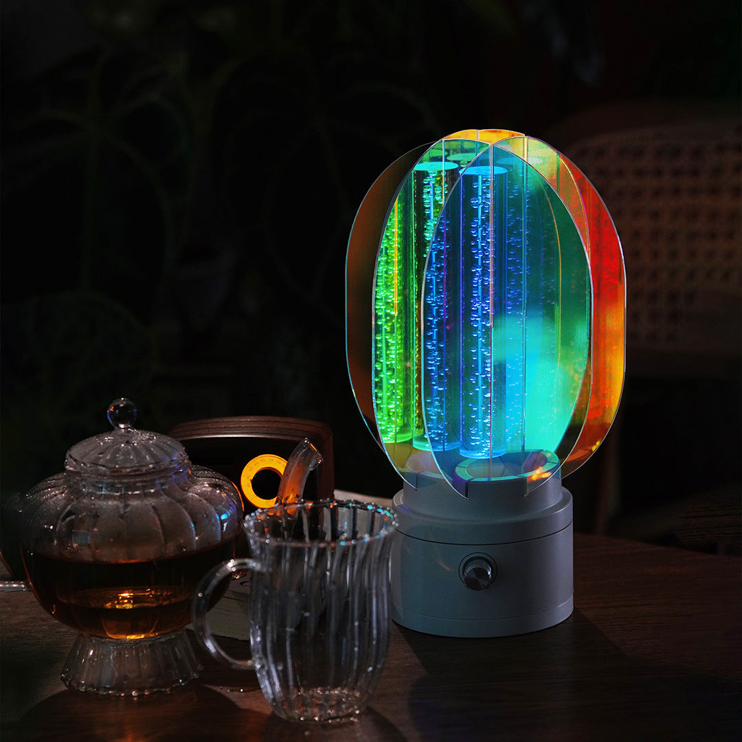 1. "VIVIENNE RAINBOW METAL TABLE LAMP"  
   A vibrant blend of colors and artistic design, this aluminum table lamp radiates warmth and creativity with its unique LED illumination.

2. "HAMPSTEAD ARTISANAL RAINBOW LAMP"  
   A striking fusion of color and