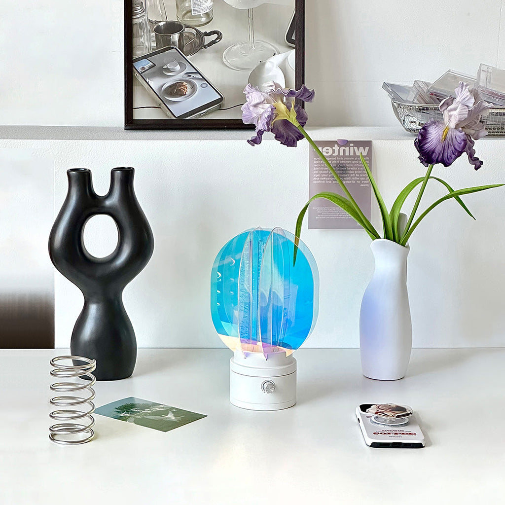 1. "VIVIENNE RAINBOW METAL TABLE LAMP"  
   A vibrant blend of colors and artistic design, this aluminum table lamp radiates warmth and creativity with its unique LED illumination.

2. "HAMPSTEAD ARTISANAL RAINBOW LAMP"  
   A striking fusion of color and