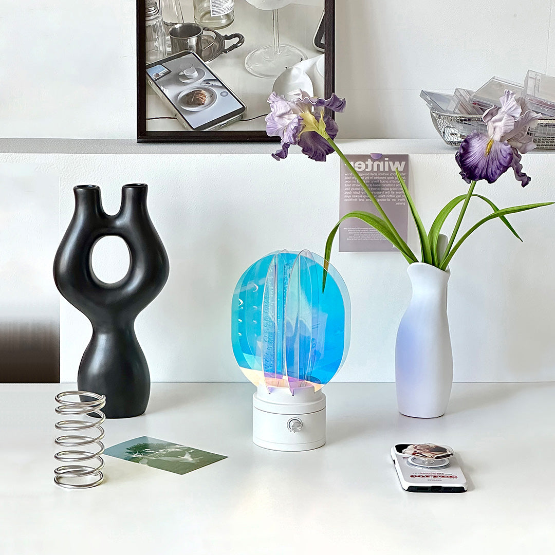 1. "VIVIENNE RAINBOW METAL TABLE LAMP"  
   A vibrant blend of colors and artistic design, this aluminum table lamp radiates warmth and creativity with its unique LED illumination.

2. "HAMPSTEAD ARTISANAL RAINBOW LAMP"  
   A striking fusion of color and