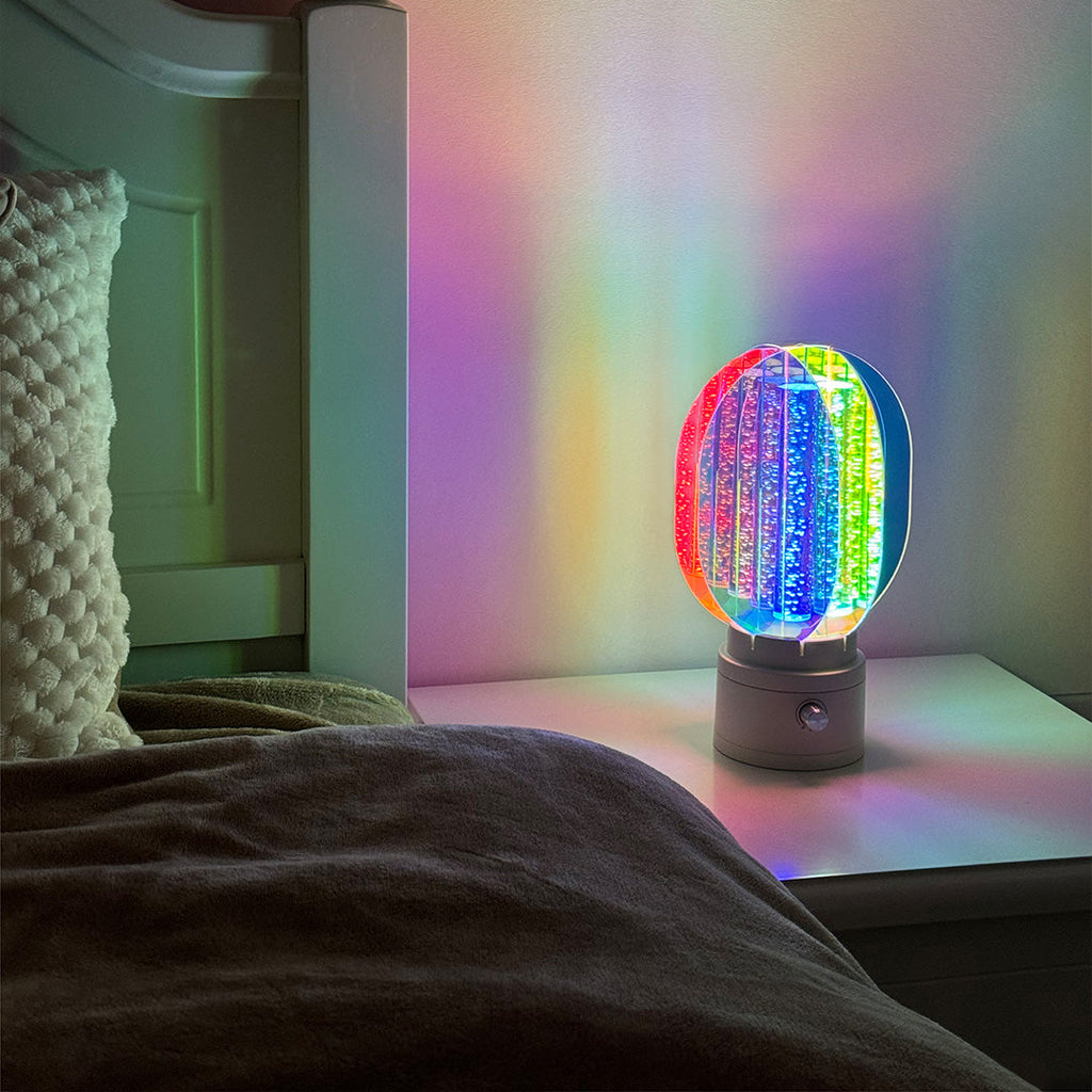 1. "VIVIENNE RAINBOW METAL TABLE LAMP"  
   A vibrant blend of colors and artistic design, this aluminum table lamp radiates warmth and creativity with its unique LED illumination.

2. "HAMPSTEAD ARTISANAL RAINBOW LAMP"  
   A striking fusion of color and