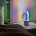 1. "VIVIENNE RAINBOW METAL TABLE LAMP"  
   A vibrant blend of colors and artistic design, this aluminum table lamp radiates warmth and creativity with its unique LED illumination.

2. "HAMPSTEAD ARTISANAL RAINBOW LAMP"  
   A striking fusion of color and