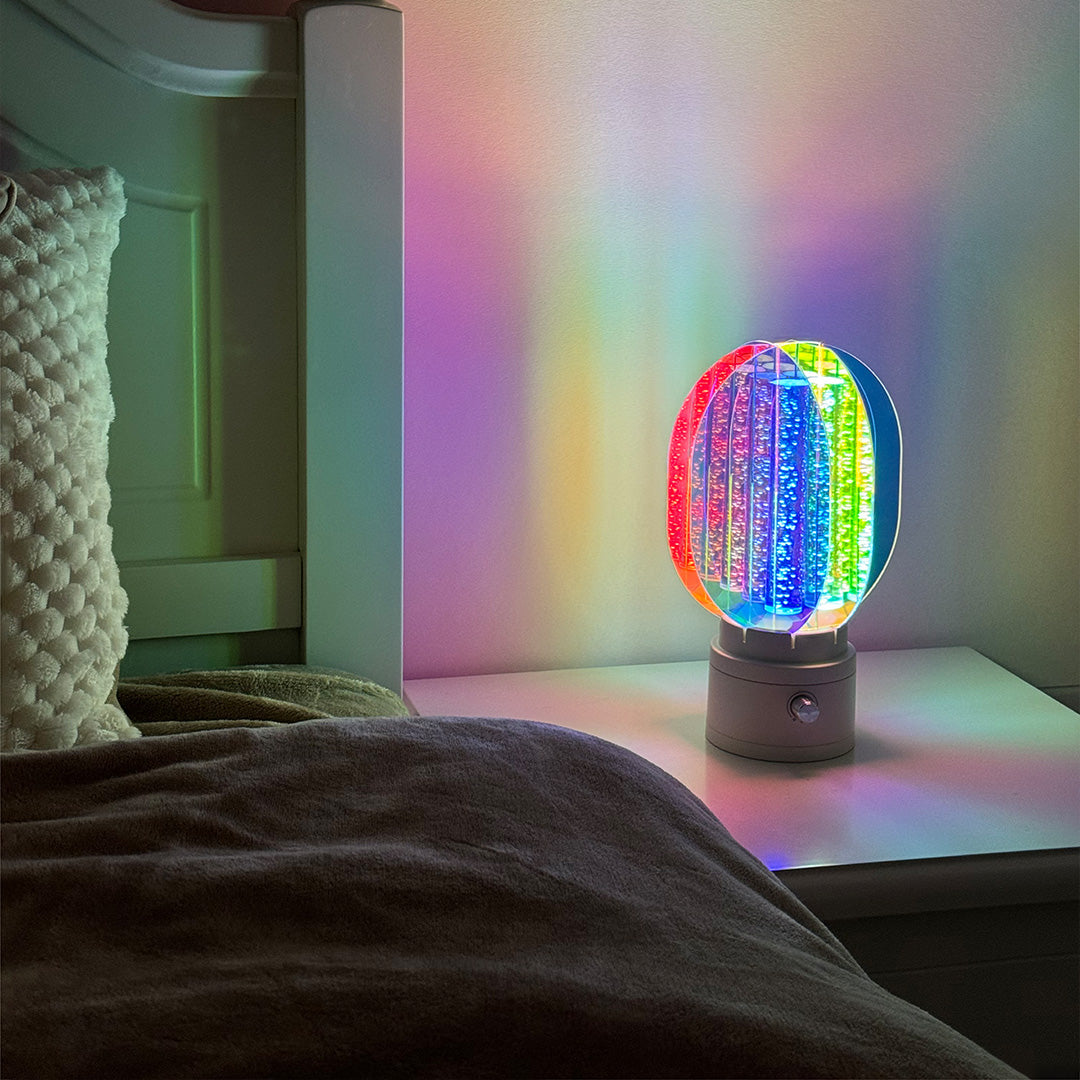 1. "VIVIENNE RAINBOW METAL TABLE LAMP"  
   A vibrant blend of colors and artistic design, this aluminum table lamp radiates warmth and creativity with its unique LED illumination.

2. "HAMPSTEAD ARTISANAL RAINBOW LAMP"  
   A striking fusion of color and