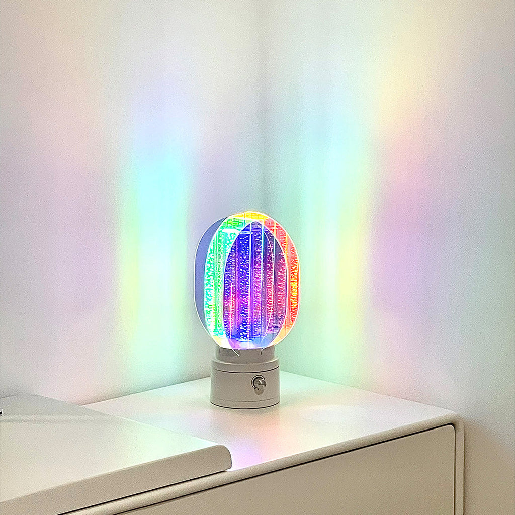 1. "VIVIENNE RAINBOW METAL TABLE LAMP"  
   A vibrant blend of colors and artistic design, this aluminum table lamp radiates warmth and creativity with its unique LED illumination.

2. "HAMPSTEAD ARTISANAL RAINBOW LAMP"  
   A striking fusion of color and